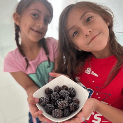Two girls holding berries